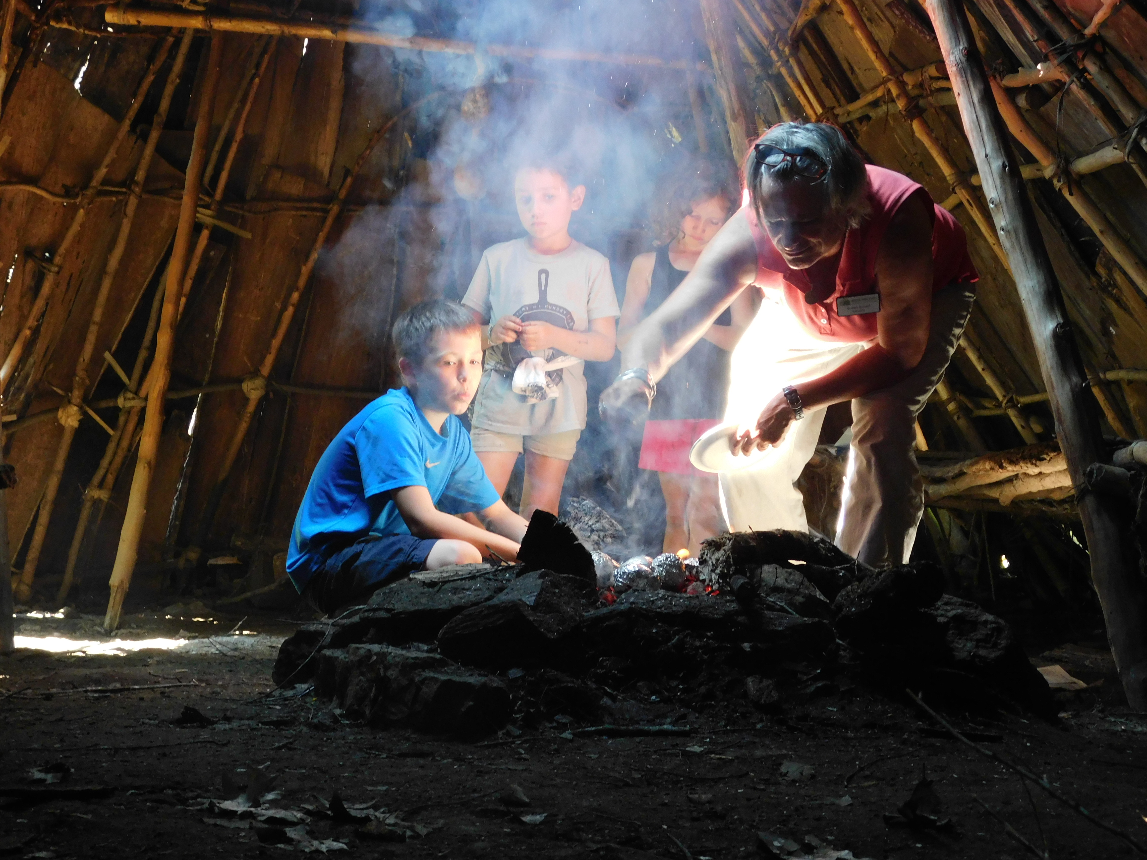 Campers stoking a campfire
