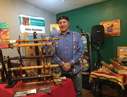 Flute Player Alan Madahbee stands with his hand crafted flutes