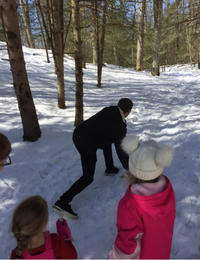 picture of kids playing a traditional game of snow snake