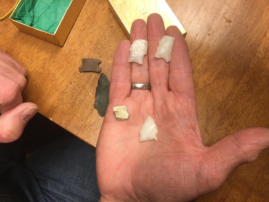 Hand holding tiny artifacts