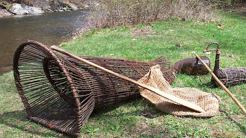 Native fishing equipment set out on the lawn.